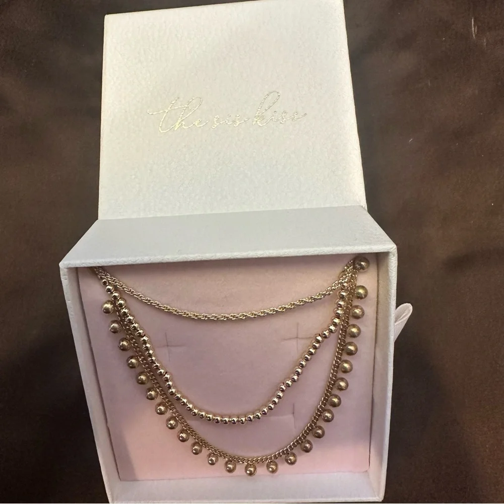 The sis kiss gold tone triple layered signed necklace with original box